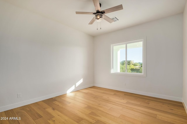 spare room with light hardwood / wood-style floors and ceiling fan