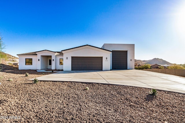 view of front of property with a mountain view and a garage