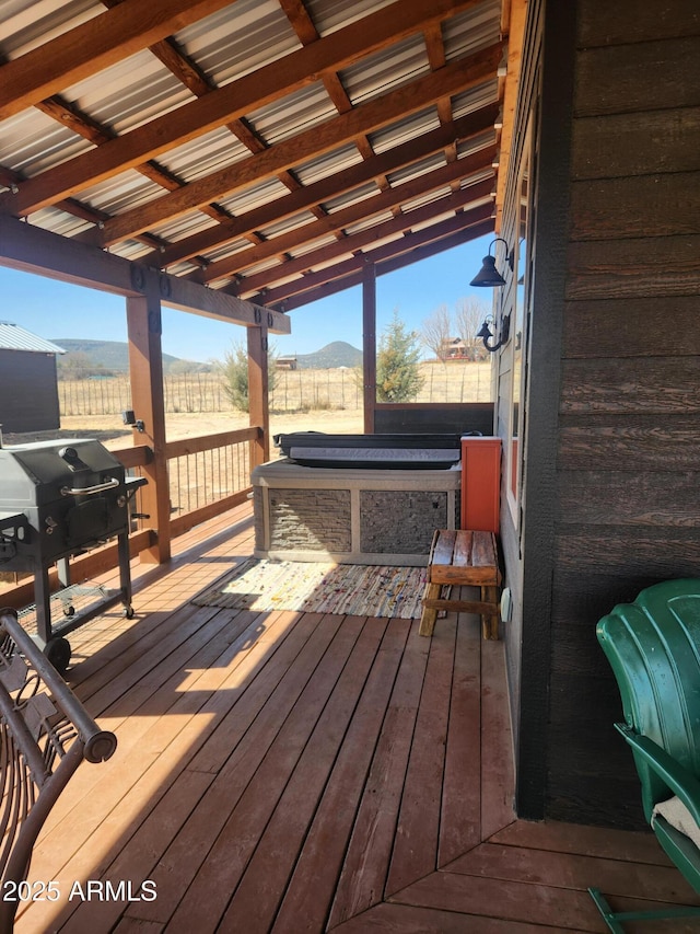 deck featuring a rural view and fence