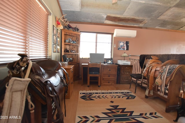 office space featuring an AC wall unit and light wood-style floors