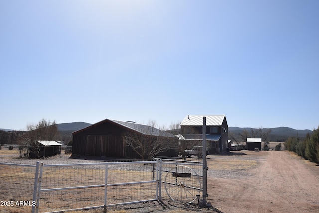 view of road featuring a rural view, a mountain view, and driveway