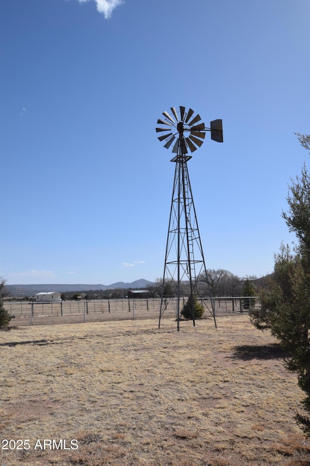 view of yard with a rural view and fence