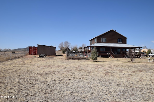 view of yard featuring an outbuilding and fence