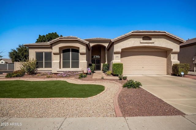 view of front of home featuring a tile roof, stucco siding, an attached garage, and concrete driveway