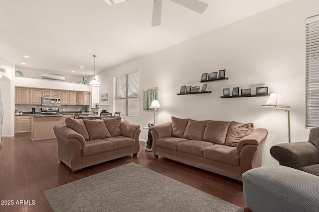 living room featuring recessed lighting, a ceiling fan, and dark wood-style flooring