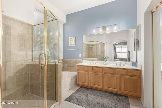 bathroom with tile patterned floors, a stall shower, a bath, and a sink