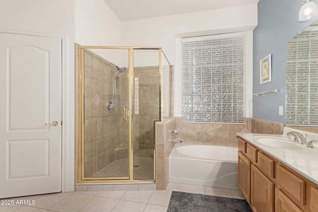 full bath with tile patterned floors, a stall shower, plenty of natural light, a bath, and vanity