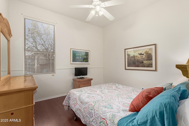 bedroom with baseboards, dark wood-type flooring, and ceiling fan