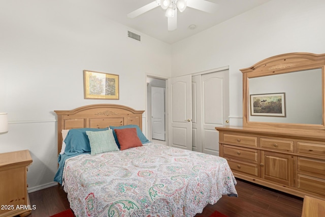 bedroom featuring a closet, visible vents, dark wood finished floors, and a ceiling fan