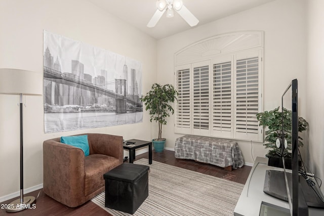 living area featuring ceiling fan, baseboards, and wood finished floors