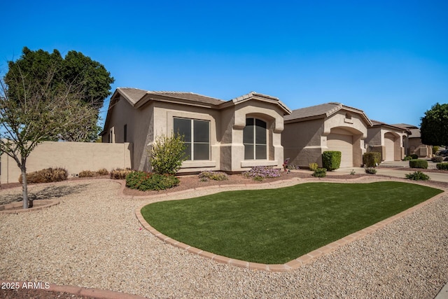 view of front of house featuring a front lawn, fence, a tile roof, and stucco siding