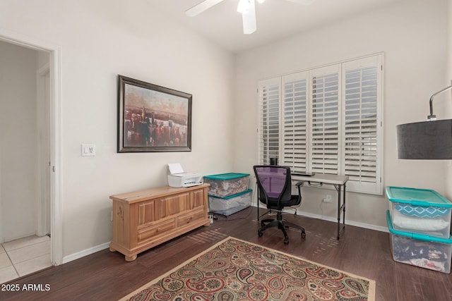 office space with baseboards, ceiling fan, and wood finished floors