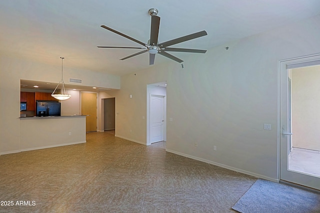 unfurnished living room featuring ceiling fan, light flooring, and baseboards