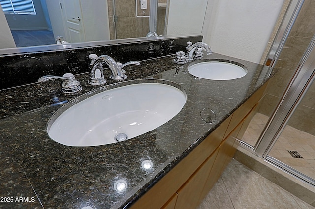 full bathroom with a shower stall, tile patterned floors, and double vanity