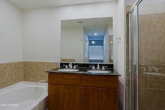 full bath with a shower stall, a garden tub, and double vanity