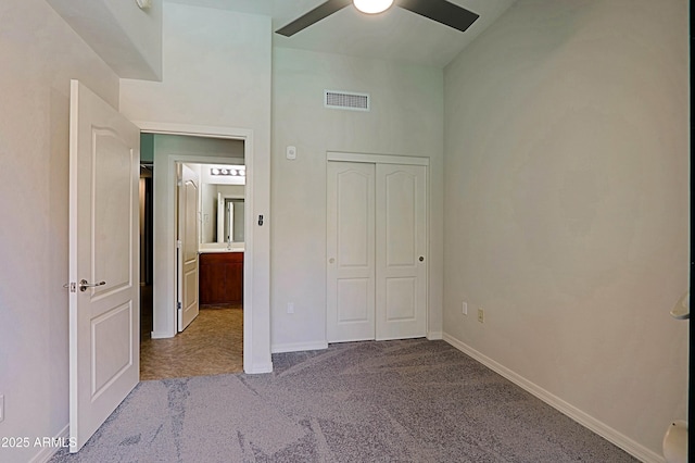 unfurnished bedroom featuring carpet flooring, baseboards, ceiling fan, and a closet