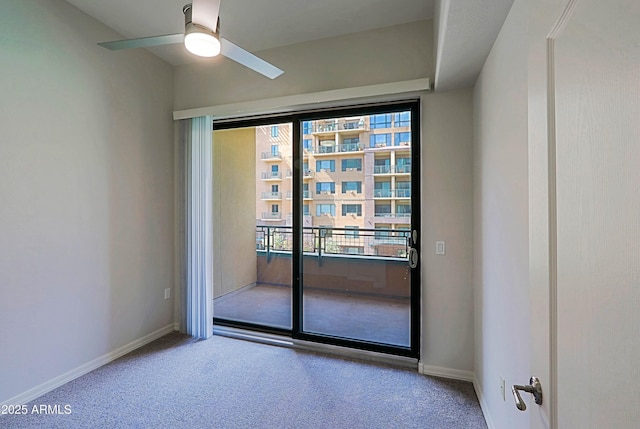empty room featuring carpet flooring, a ceiling fan, and baseboards