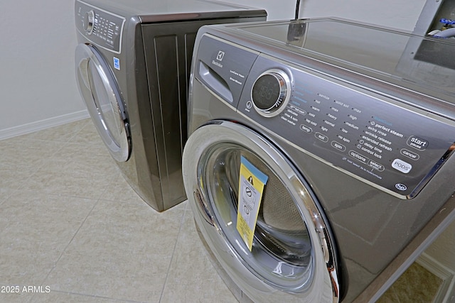 washroom with independent washer and dryer and light tile patterned floors