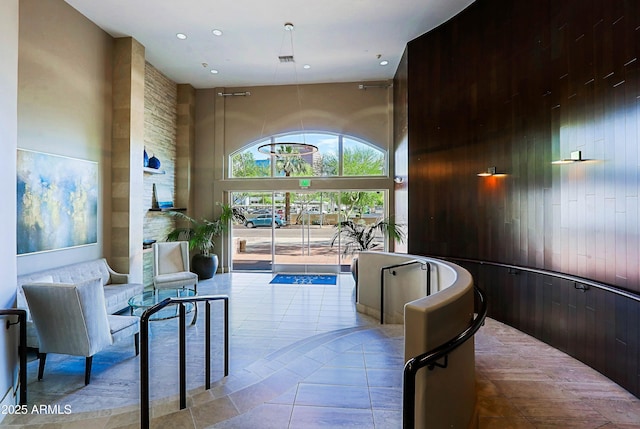 building lobby featuring a towering ceiling and recessed lighting