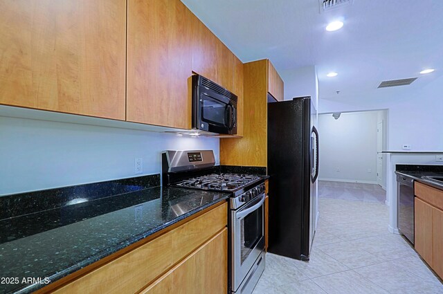 kitchen with black appliances, dark stone counters, light tile patterned floors, recessed lighting, and modern cabinets