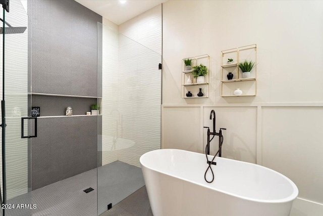 bathroom featuring shower with separate bathtub