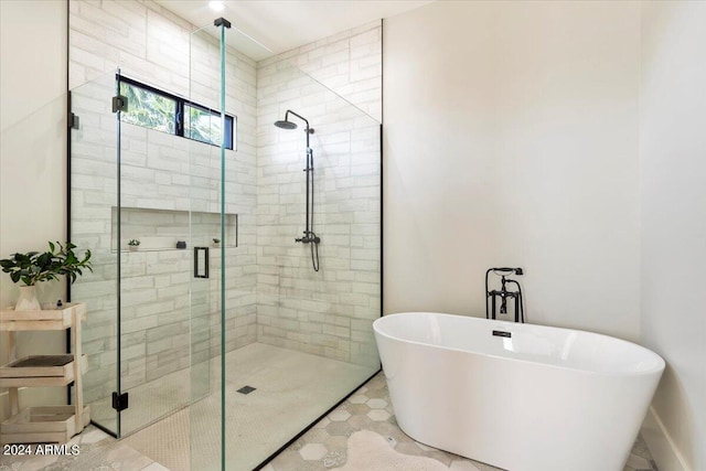 bathroom featuring plus walk in shower and tile patterned flooring