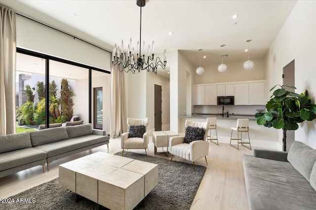 living room featuring light hardwood / wood-style flooring and a towering ceiling