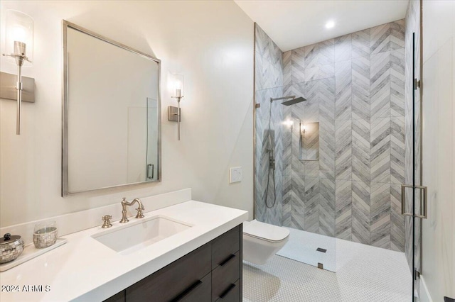 bathroom with vanity, a shower with shower door, toilet, and tile patterned floors