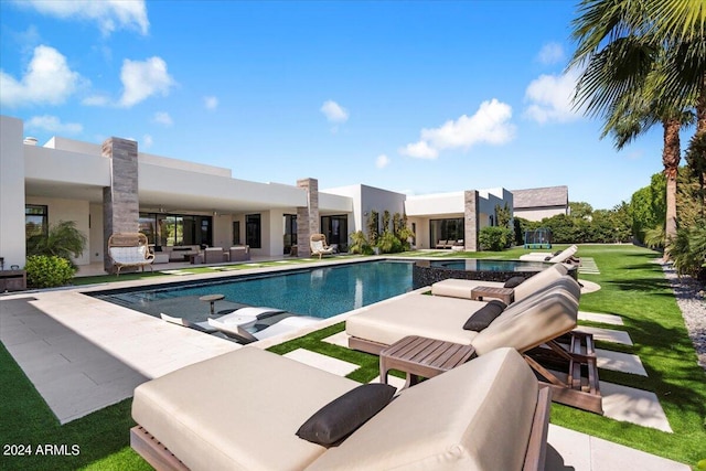 view of pool featuring a patio and a lawn