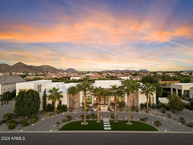 view of front of home with a yard and a mountain view