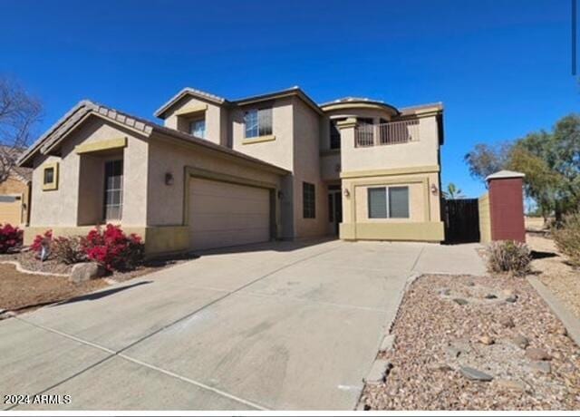 view of front of home with a garage and a balcony