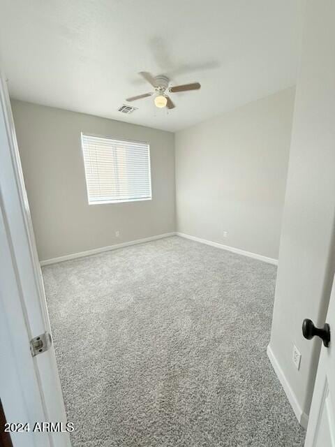 empty room with carpet floors and ceiling fan