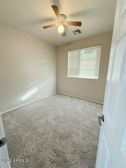 carpeted empty room featuring ceiling fan