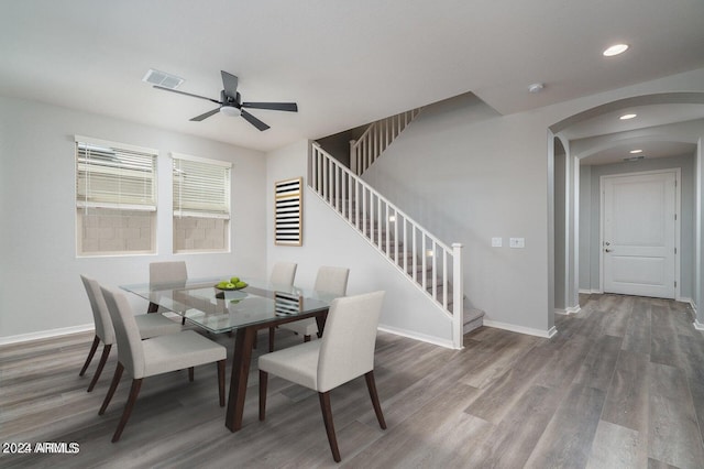 dining area with wood-type flooring and ceiling fan