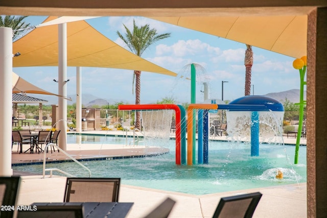 view of swimming pool featuring pool water feature and a mountain view