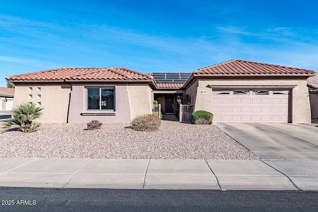 view of front of property featuring a garage and solar panels