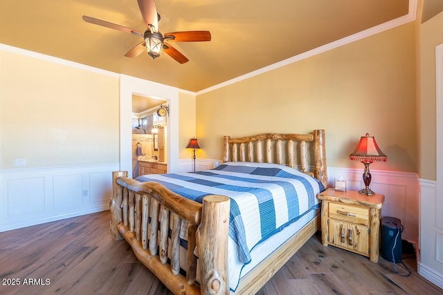 bedroom with vaulted ceiling, ceiling fan, dark hardwood / wood-style flooring, ensuite bath, and ornamental molding