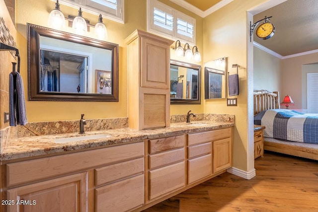 bathroom featuring hardwood / wood-style flooring, vanity, and crown molding