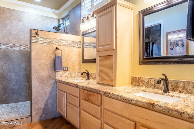 bathroom with walk in shower, wood-type flooring, vanity, and ornamental molding