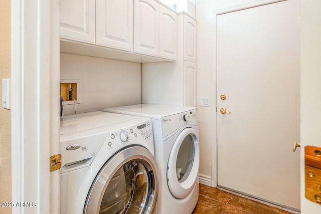 washroom featuring cabinets and separate washer and dryer