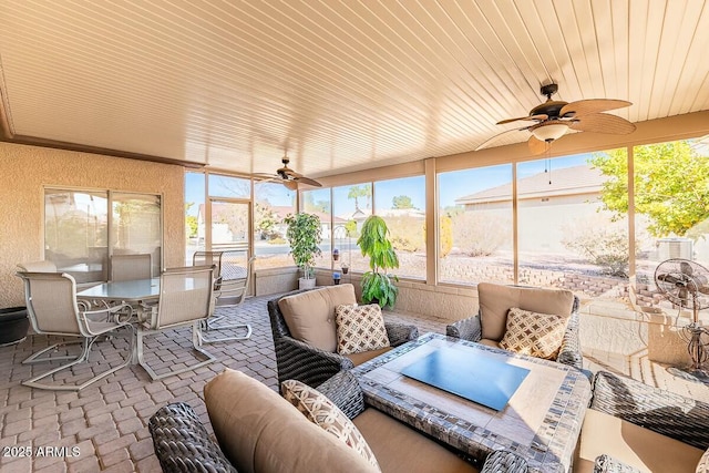 sunroom / solarium with ceiling fan and wooden ceiling