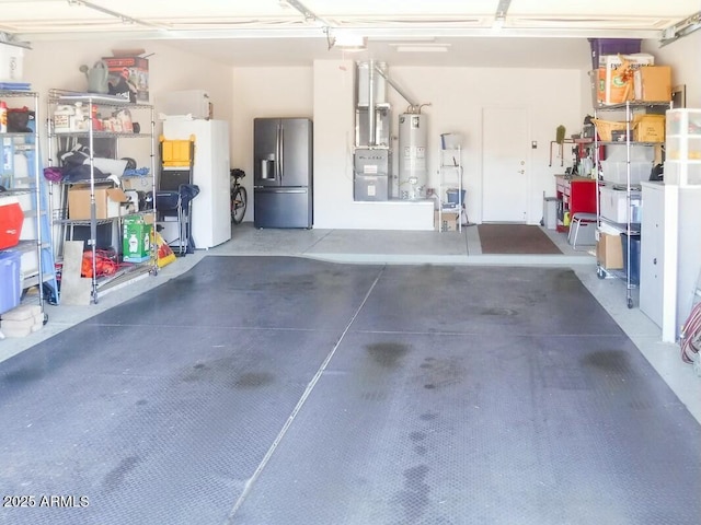 garage with stainless steel refrigerator with ice dispenser, fridge, and water heater