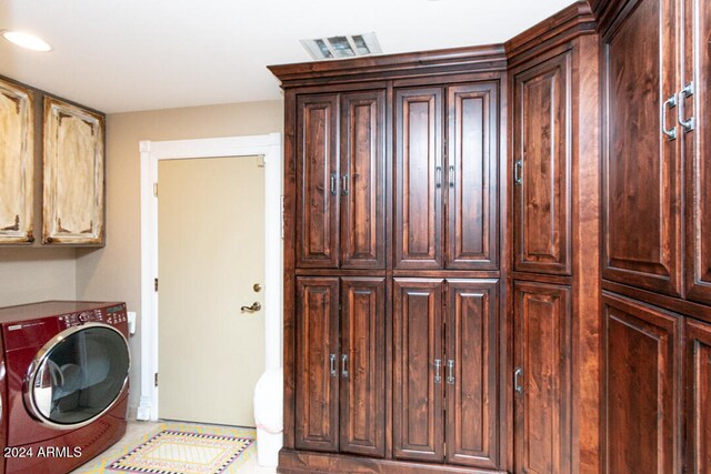 washroom featuring cabinets and washer / dryer