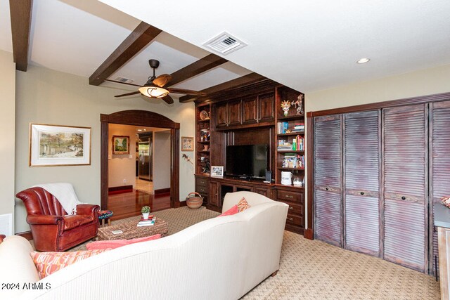 living room with beam ceiling and ceiling fan