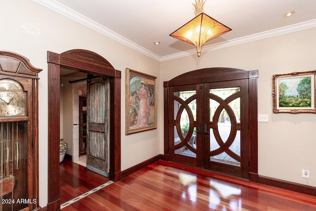 foyer featuring french doors, dark hardwood / wood-style flooring, and ornamental molding