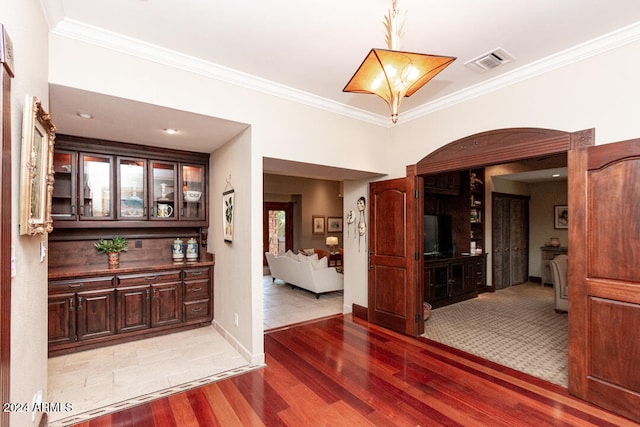 interior space featuring hardwood / wood-style floors and crown molding