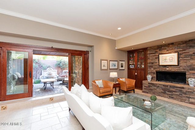 living room with a stone fireplace, crown molding, and french doors