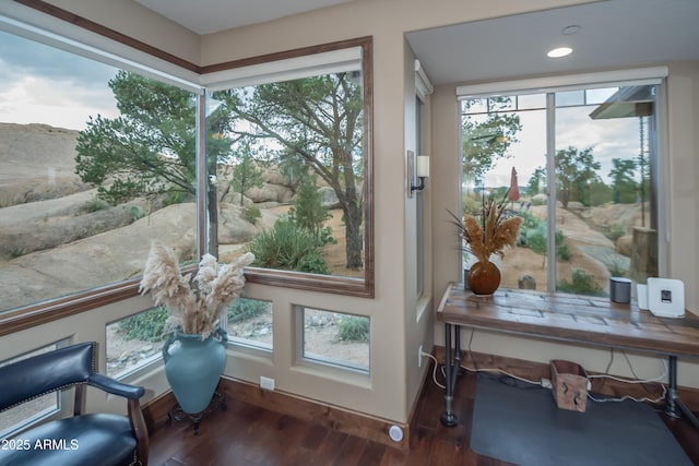 interior space featuring baseboards, dark wood-style flooring, recessed lighting, and a healthy amount of sunlight