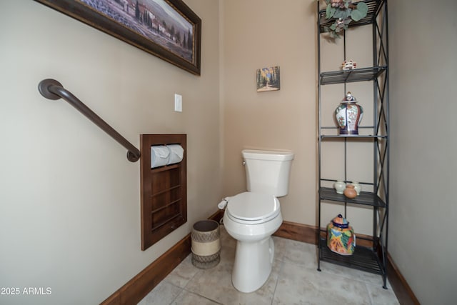 half bathroom with baseboards, toilet, and tile patterned floors