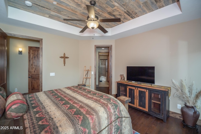 bedroom with wood ceiling, a ceiling fan, a raised ceiling, and dark wood finished floors